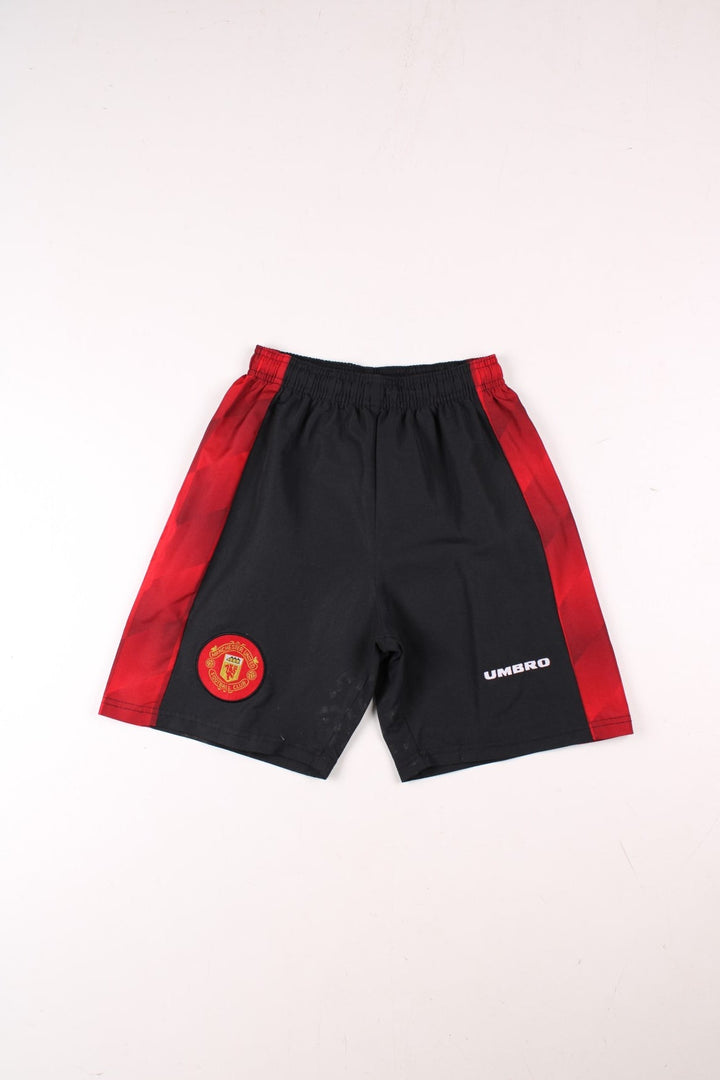 1996-98 Umbro Manchester United home kit shorts in black with red side panels, an elasticated waist, and embroidered Umbro and Man U logos on the front.