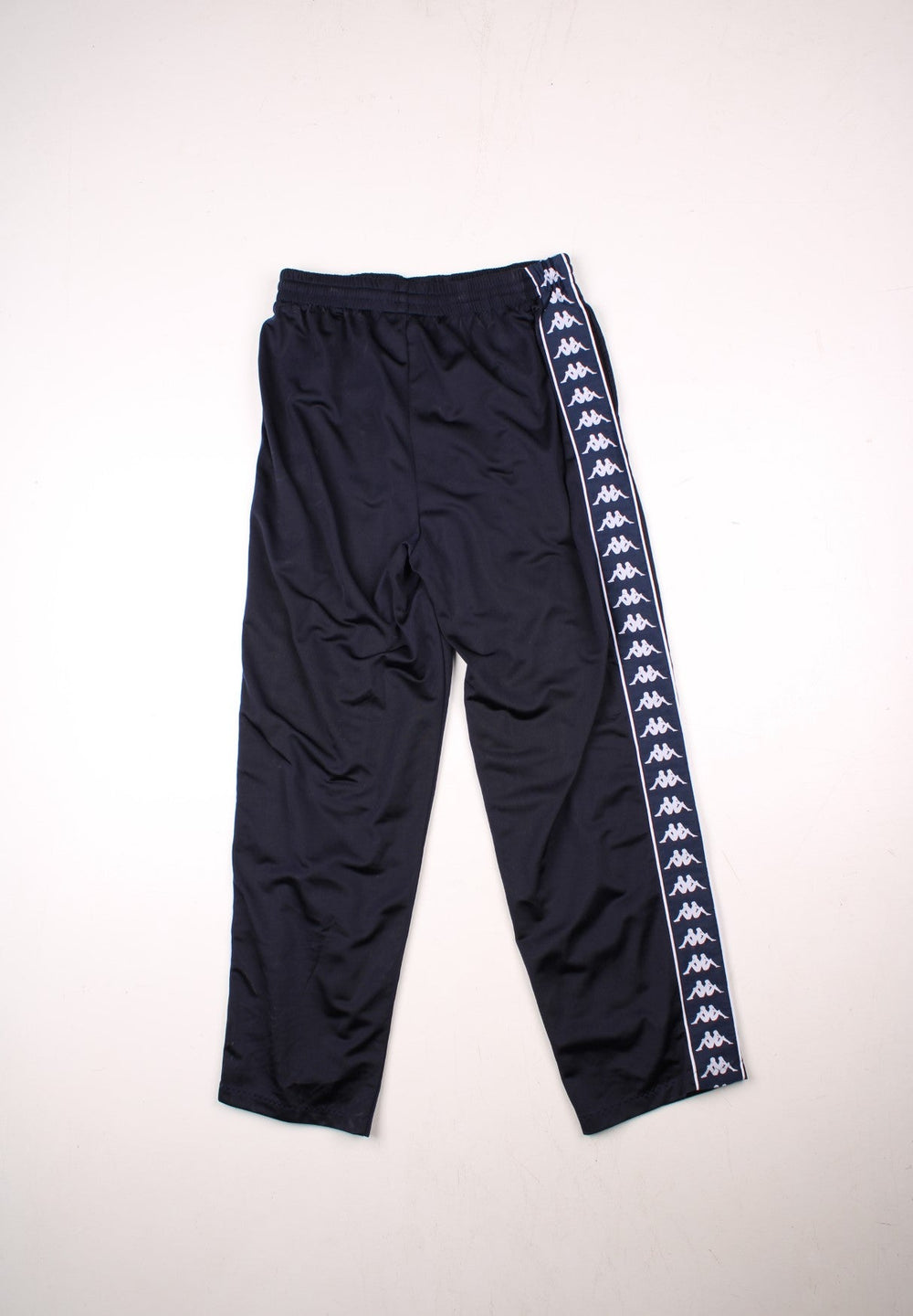 Kappa tracksuit bottoms in navy blue with an elasticated waist, two pockets, logo tape down each side and an embroidered logo on the front.