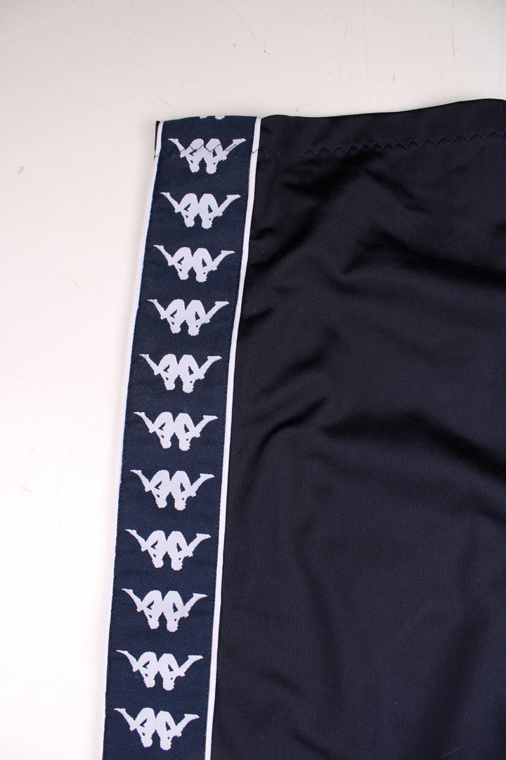 Kappa tracksuit bottoms in navy blue with an elasticated waist, two pockets, logo tape down each side and an embroidered logo on the front.