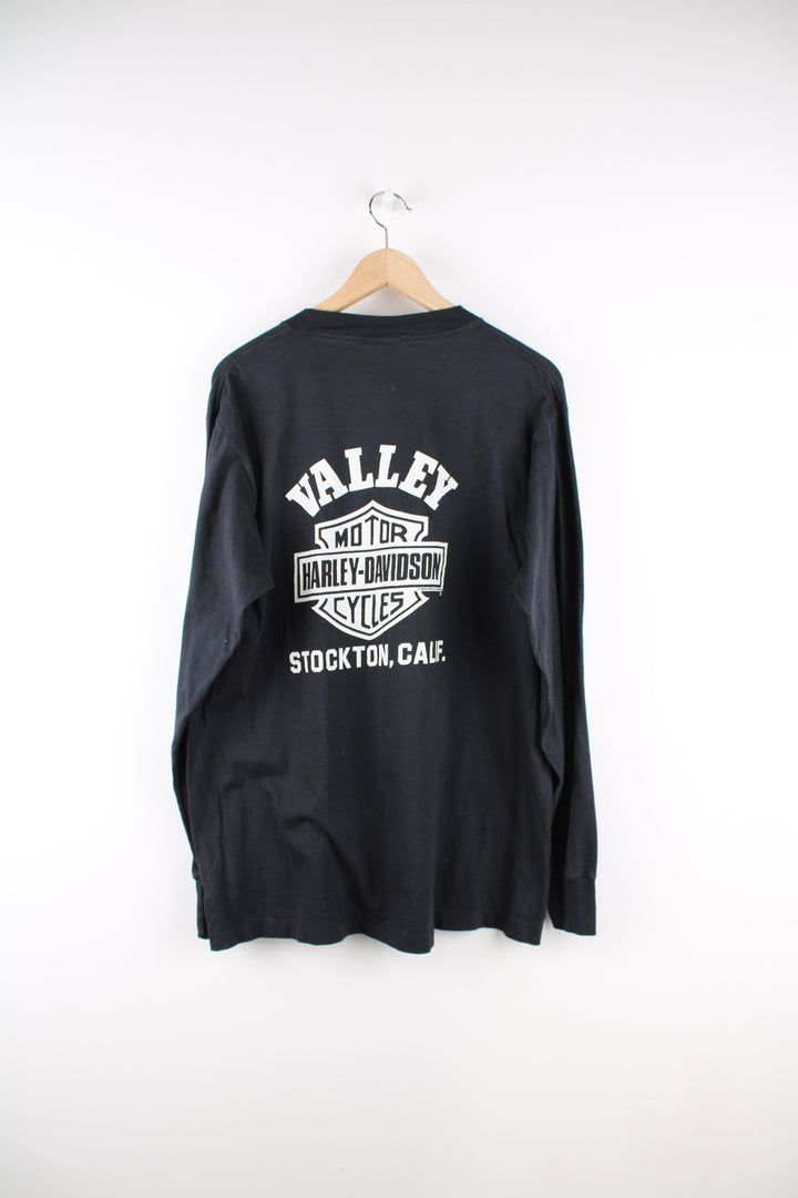 Vintage made in the USA 1980's Harley-Davidson Stockton California all black long sleeve top with printed spell-out graphics on the back and down the sleeves, eagle on the chest pocket