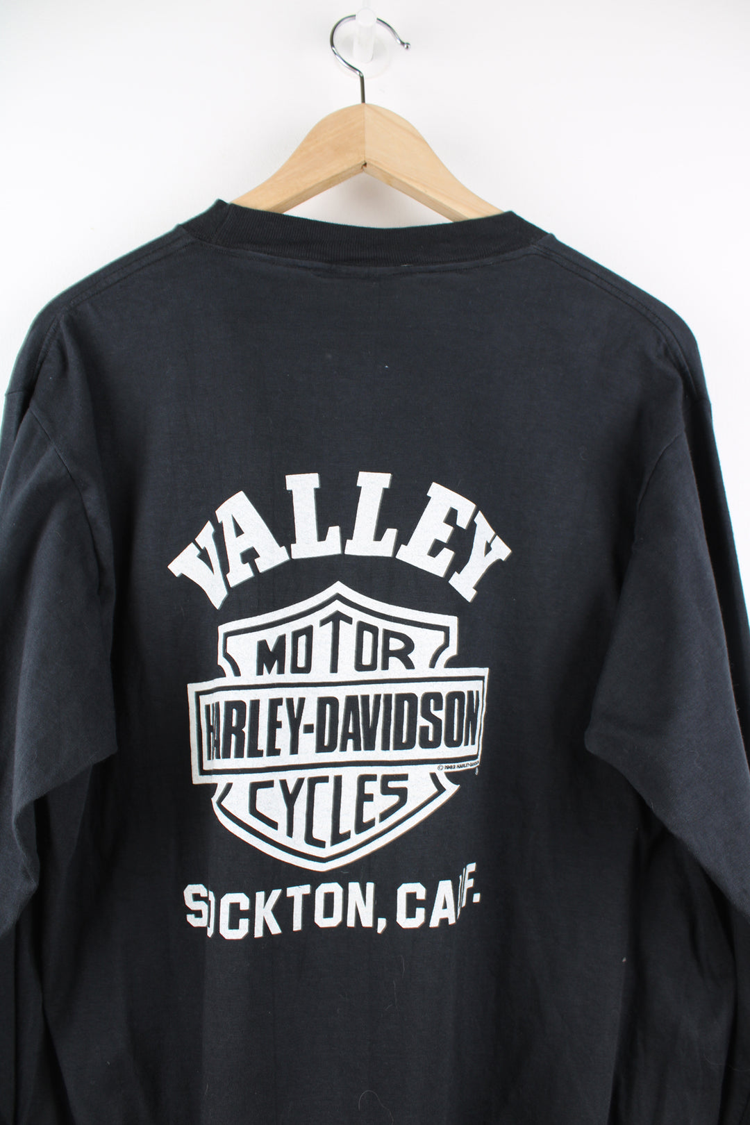 Vintage made in the USA 1980's Harley-Davidson Stockton California all black long sleeve top with printed spell-out graphics on the back and down the sleeves, eagle on the chest pocket