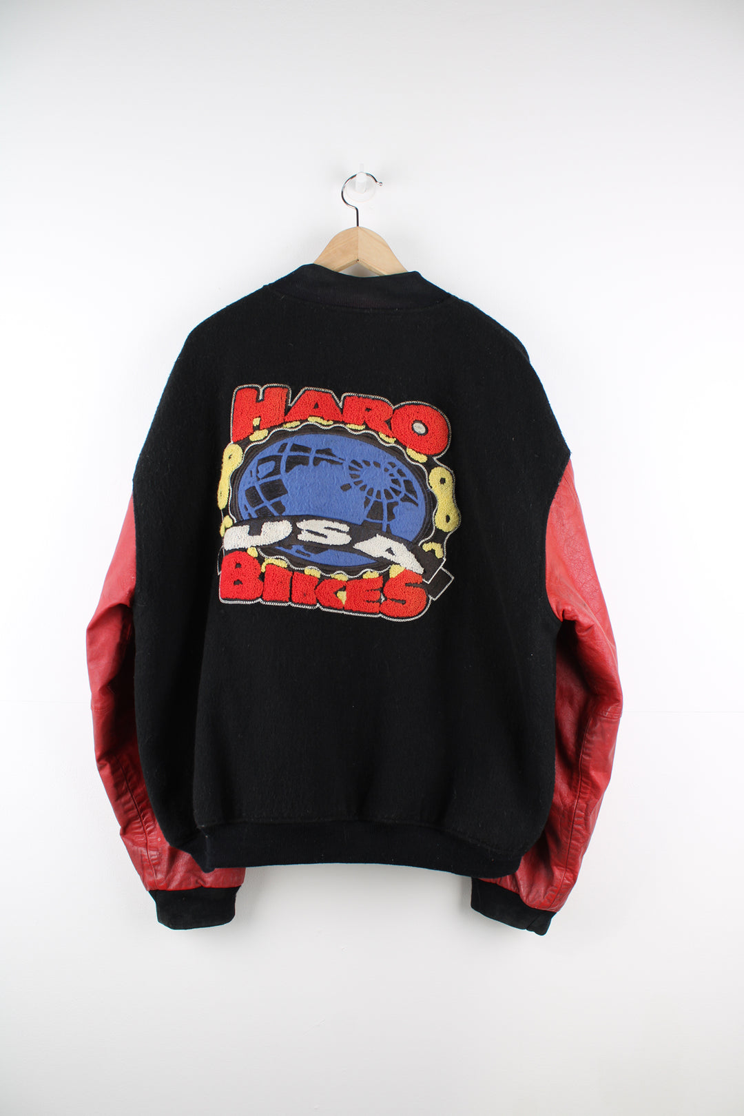 Vintage HARO BMX Bikes, black wool embroidered varsity jacket with red leather sleeves, features spell-out embroidery on the sleeve, chest and back of jacket