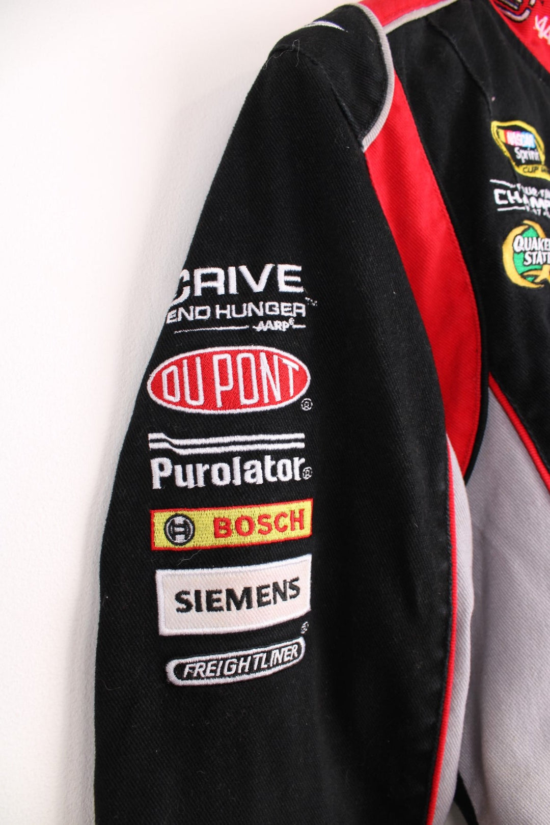 Jeff Gordon Drive To End Hunger NASCAR jacket by Chase Authentics in black, grey and red. Features embroidered sponsor logos on the front and sleeves.