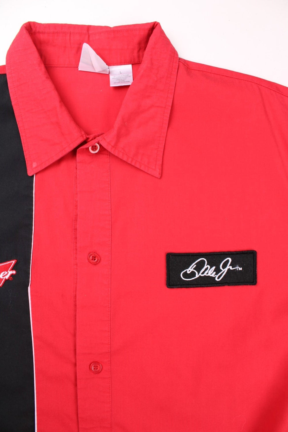 Vintage Winners Circle Budweiser Dale Jr. NASCAR short-sleeved bowling shirt in red with a black stripe, white piping, and button closure .