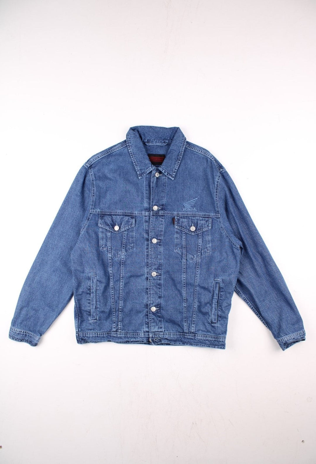 Vintage Honda denim jacket in blue, with multiple pockets, button closure, and the Honda logo embroidered on the chest and back.