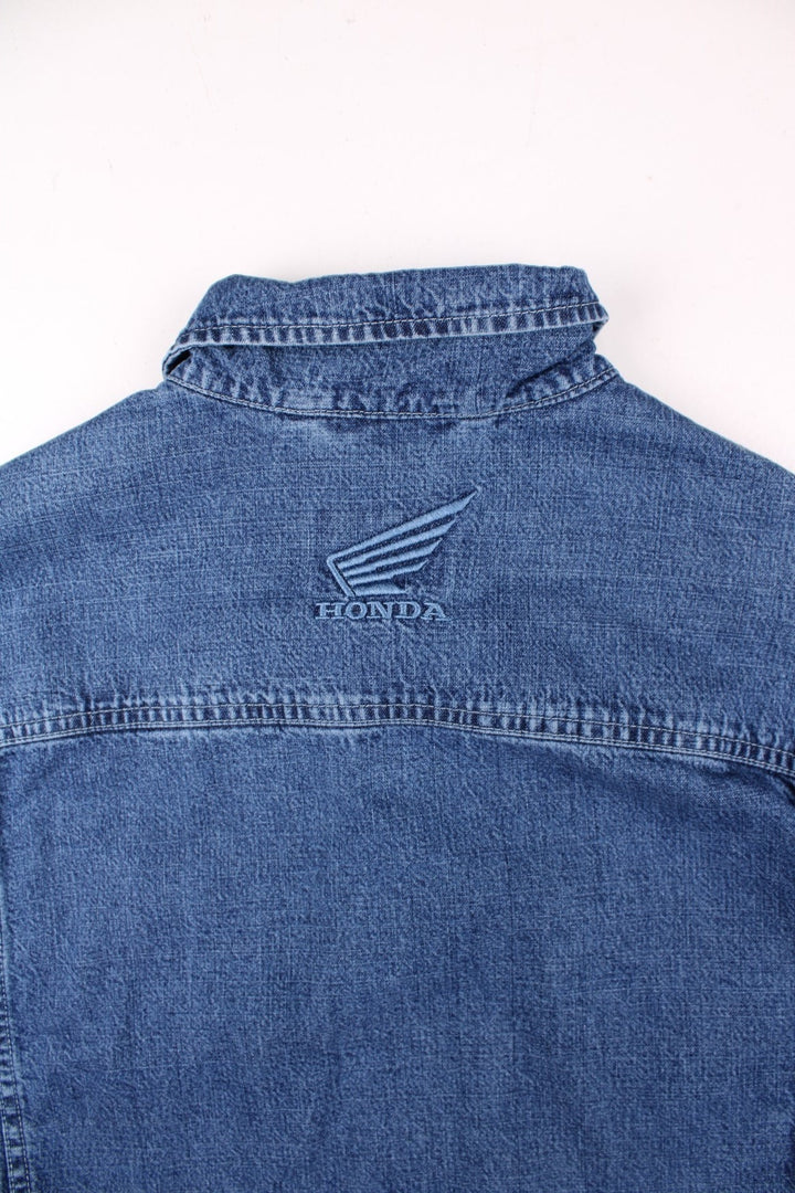 Vintage Honda denim jacket in blue, with multiple pockets, button closure, and the Honda logo embroidered on the chest and back.