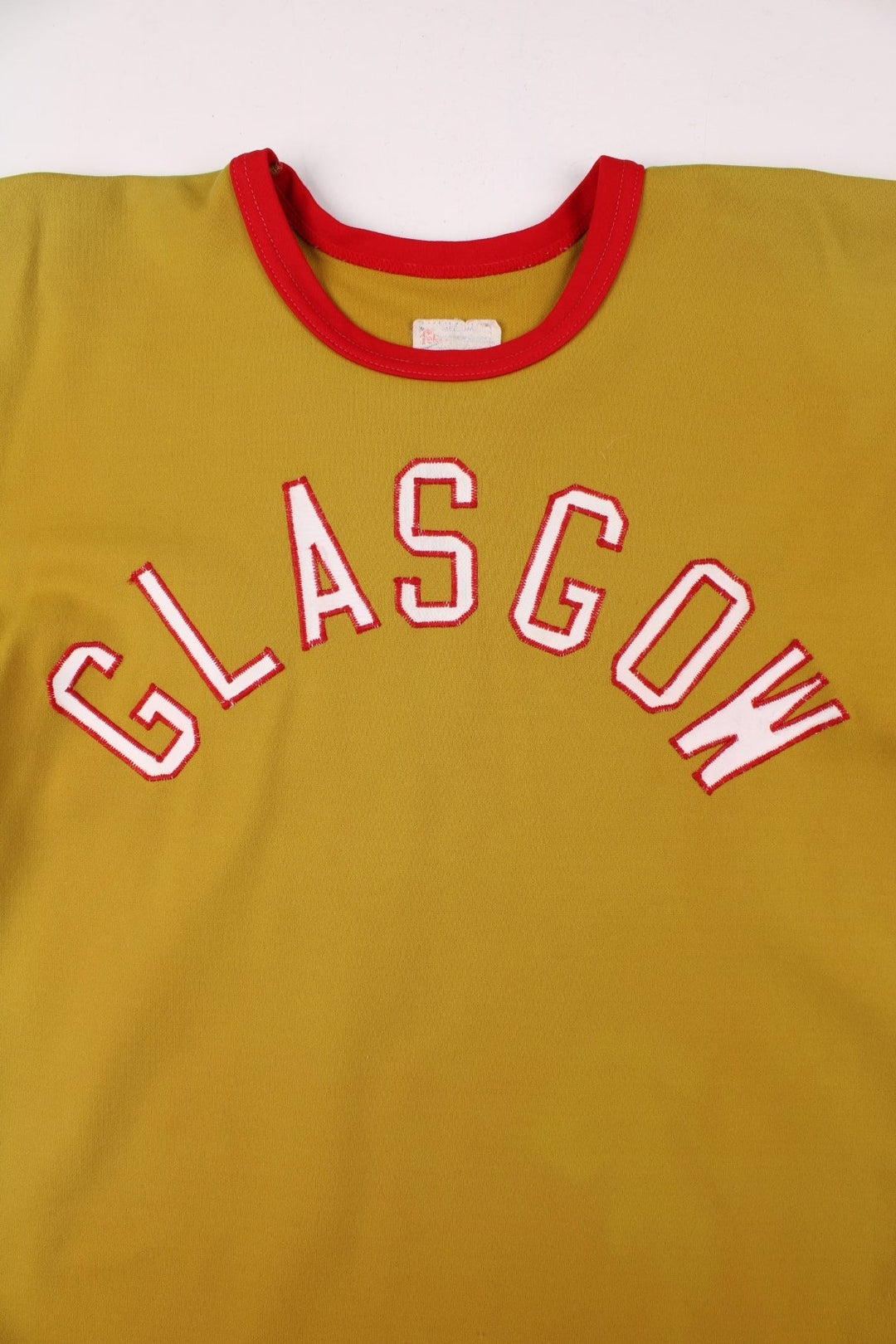 Vintage 60's Glasgow Sports Jersey in a gold yellow with red and white stripe detailing, 'Glasgow' embroidered on the front and number 29 on the back.