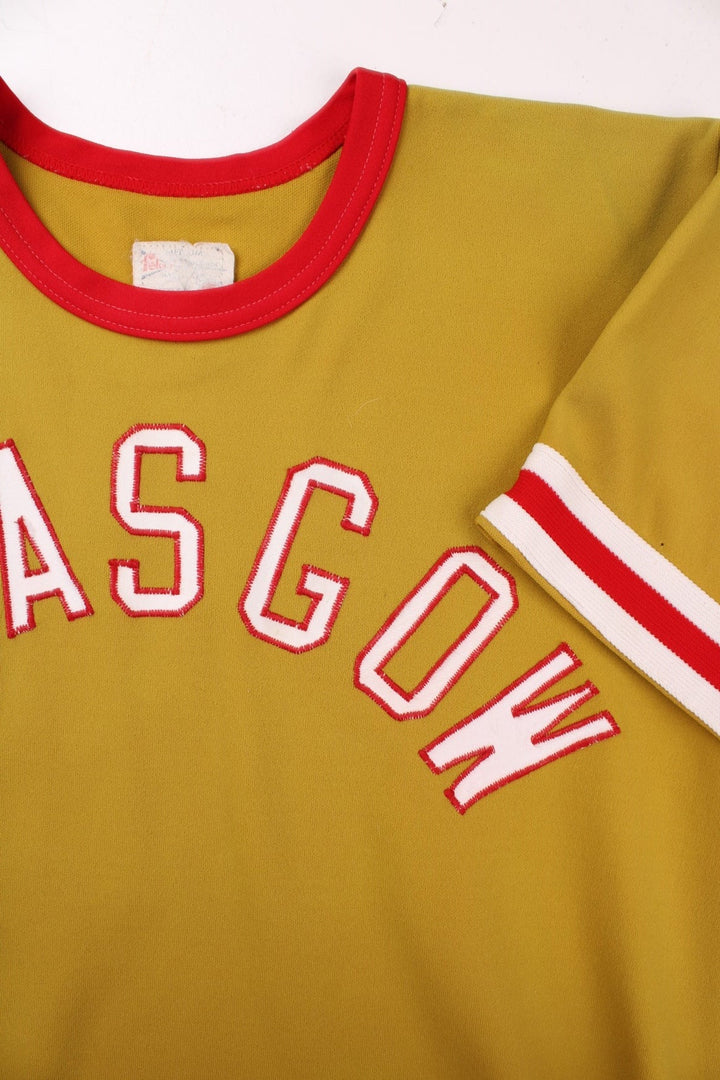 Vintage 60's Glasgow Sports Jersey in a gold yellow with red and white stripe detailing, 'Glasgow' embroidered on the front and number 29 on the back.