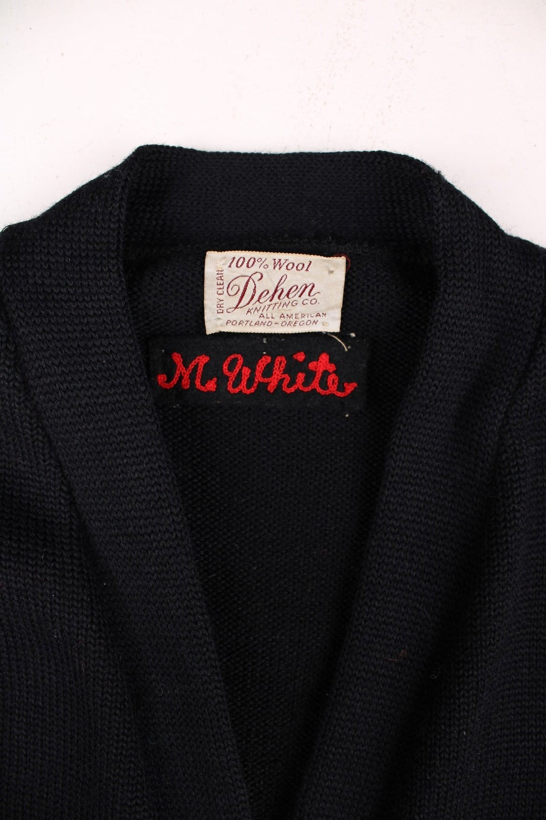 Vintage Dehen Wool Letterman Cardigan in black with button closure, two pockets, and red embroidery of a large letter T, number 74, and a tiger badge on the right sleeve.