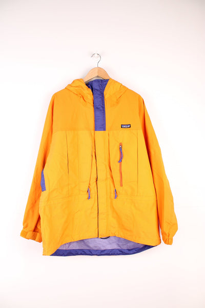 Orange and purple Patagonia hooded rain jacket with embroidered logo on the chest and multiple pockets.
