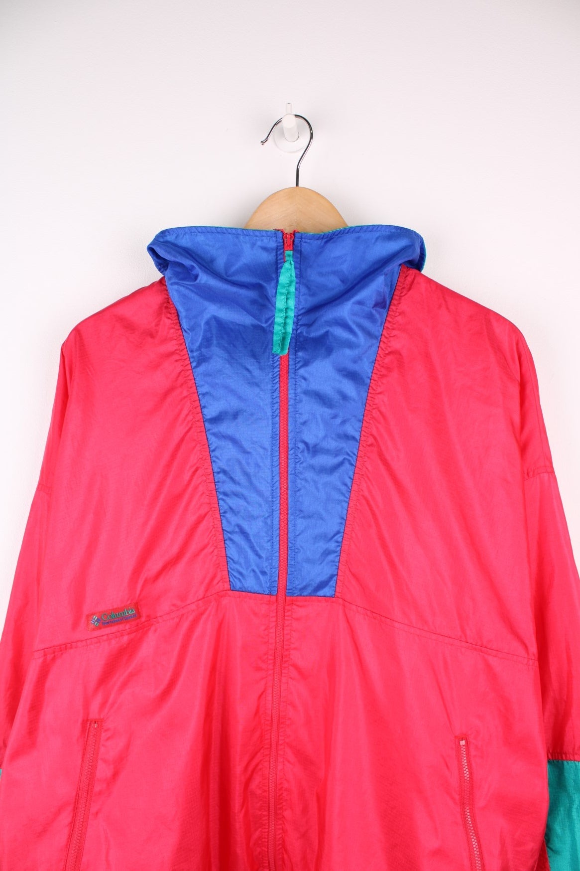 Vintage lightweight zip through Radial Sleeve windbreaker jacket by Columbia in red, blue and teal colour block Features logo on the above the right pocket.