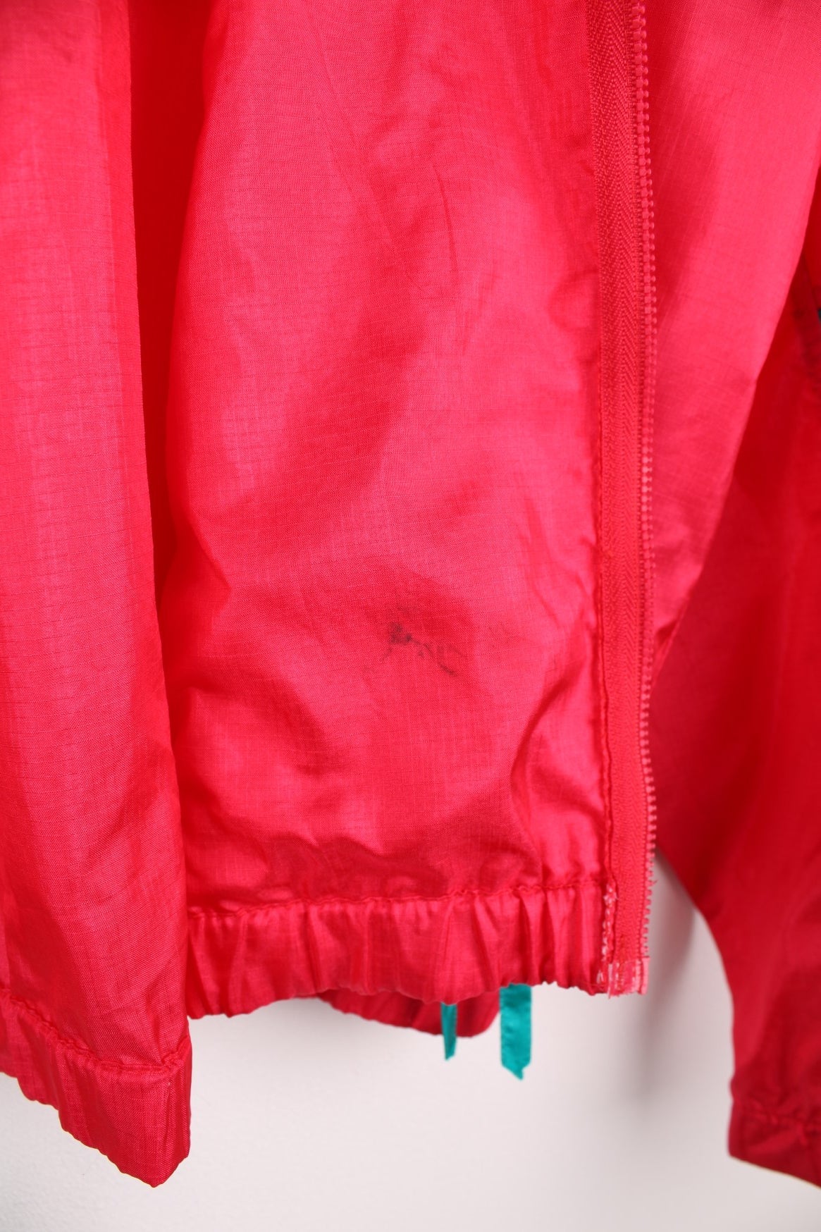 Vintage lightweight zip through Radial Sleeve windbreaker jacket by Columbia in red, blue and teal colour block Features logo on the above the right pocket.