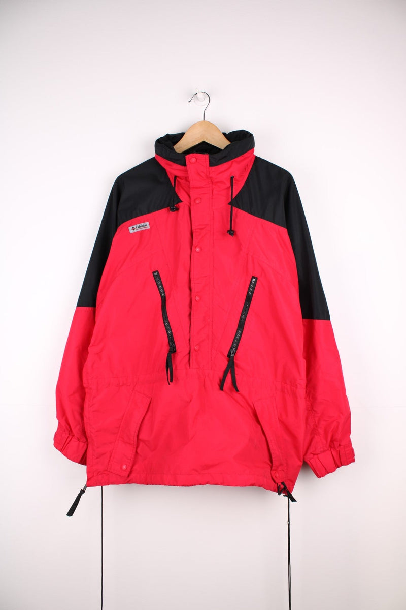 Columbia red and black zip through outdoor jacket with elasticated hem and waist. Features zip away hood, multiple pockets and embroiderd logo on the chest