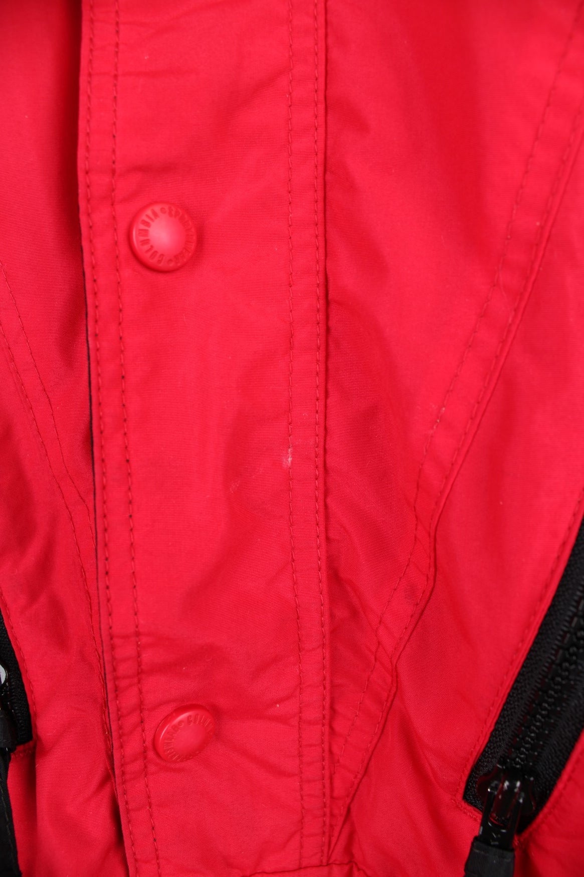 Columbia red and black zip through outdoor jacket with elasticated hem and waist. Features zip away hood, multiple pockets and embroiderd logo on the chest