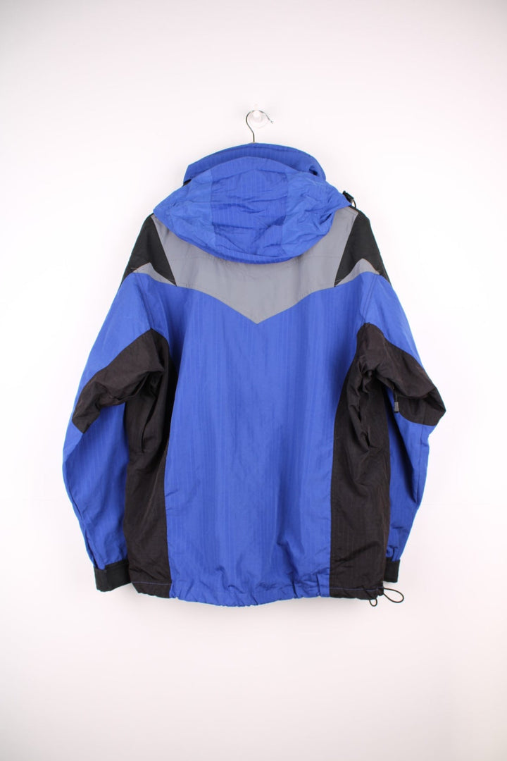 The North Face Extreme Light jacket in blue and black. Features embroidered logos, multiple pockets and foldaway hood 