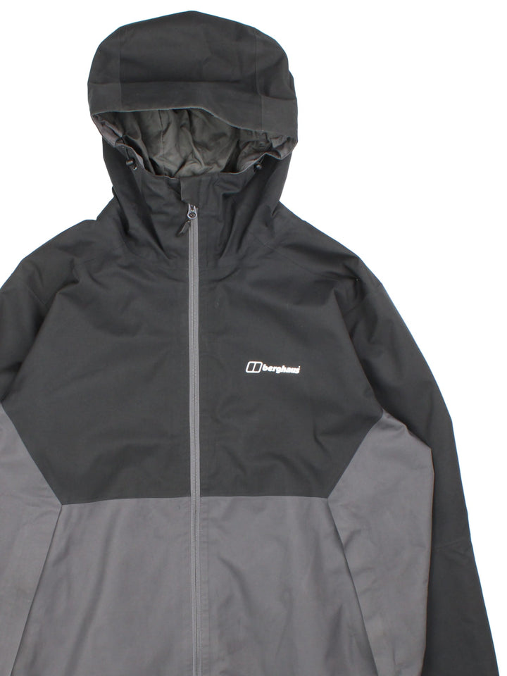 Berghaus Gortex Jacket in a black and grey colourway. Gortex waterproof shell with zip pockets and classic logo on the front.