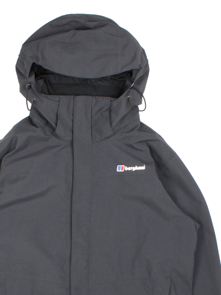 Berghaus Gortex Jacket in a black colourway. Zip double pocket on front with classic logo on chest and thin netted lining inside.