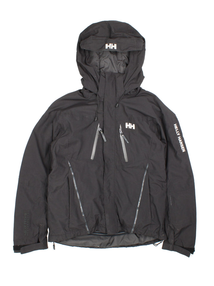 Helly Hansen Jacket in a black colourway. Full zip with multiple pockets and drawstring hood, Warmcore Primaloft technology, and has a small logo embroidered on front and down the left sleeve.