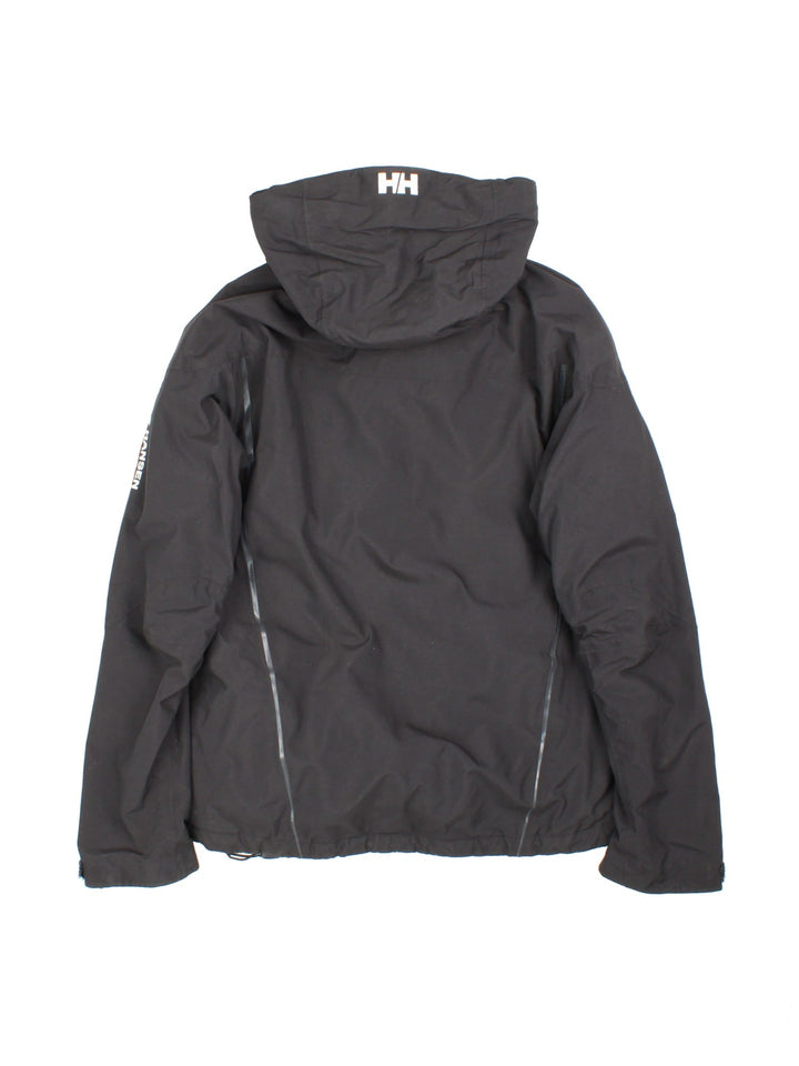 Helly Hansen Jacket in a black colourway. Full zip with multiple pockets and drawstring hood, Warmcore Primaloft technology, and has a small logo embroidered on front and down the left sleeve.