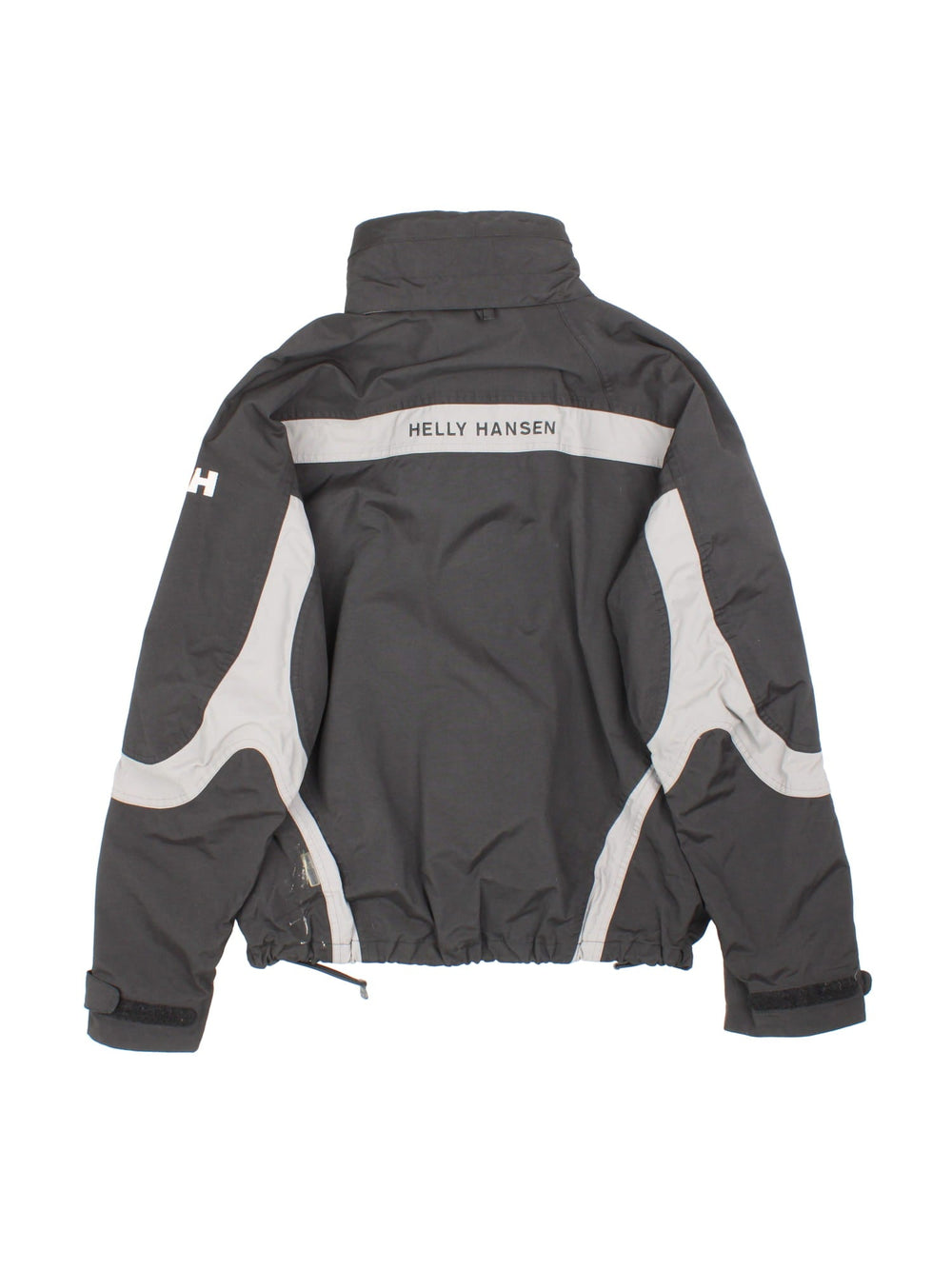 Helly Hansen Jacket in a black colourway. Multiple zip pockets and drawstring hem, and has the logo embroidered across the back and small logo on front and sleeve.