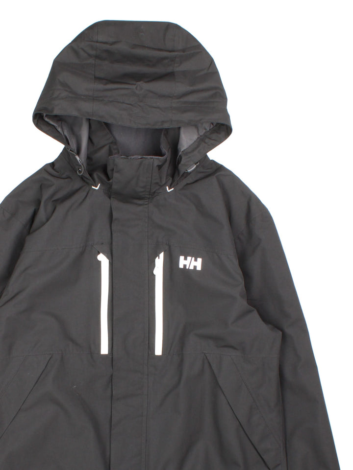 Helly Hansen Jacket in a black colourway. Multiple pockets, hooded, and has the brand logo on front and on the back under the hood.