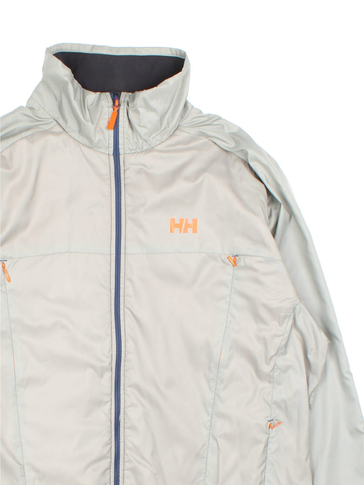 Helly Hansen Flow Jacket in a grey colourway. Multiple zip pockets and mesh interior lining, and has the brand logo on the front.