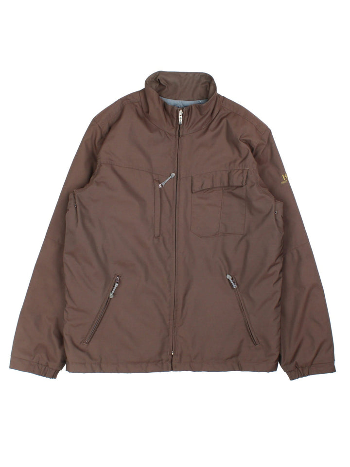 Helly Hansen Jacket in a brown colourway. Has multiple pockets, full zip closure and insulated with a quilted lining. Has the logo on the left sleeve.