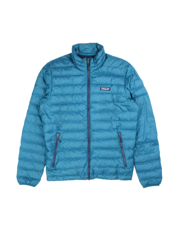 Vintage Patagonia Puffer Jacket in a blue colourway with contrast lining. Zip fastening/pockets, embroided patch logo on the front.