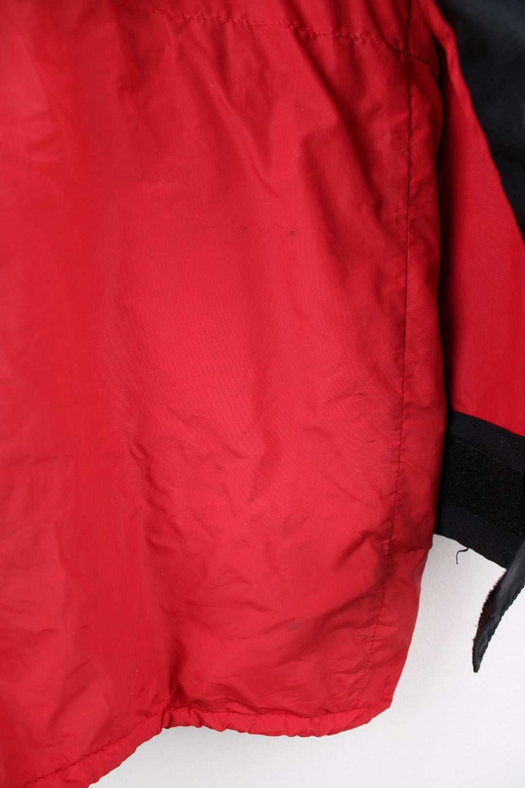 Vintage Rab red and black hooded rain jacket with multiple pockets and embroidered logo.