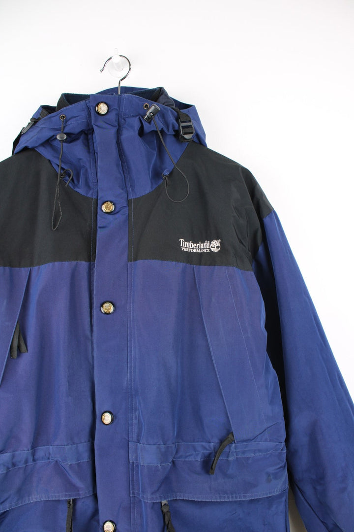 Vintage Timberland Performance Gore-Tex hooded jacket. Features removable fleece lining, embroidered logo on the chest and multiple pockets.