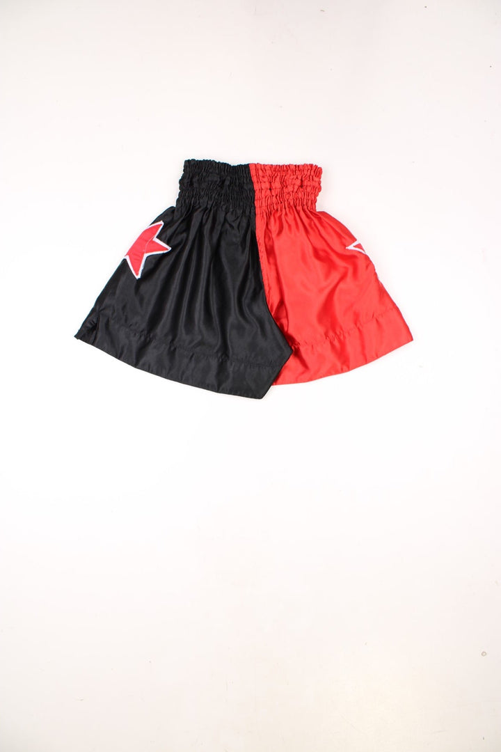 Duo Gear Thai boxing shorts in red and black with embroidered stars and lettering.