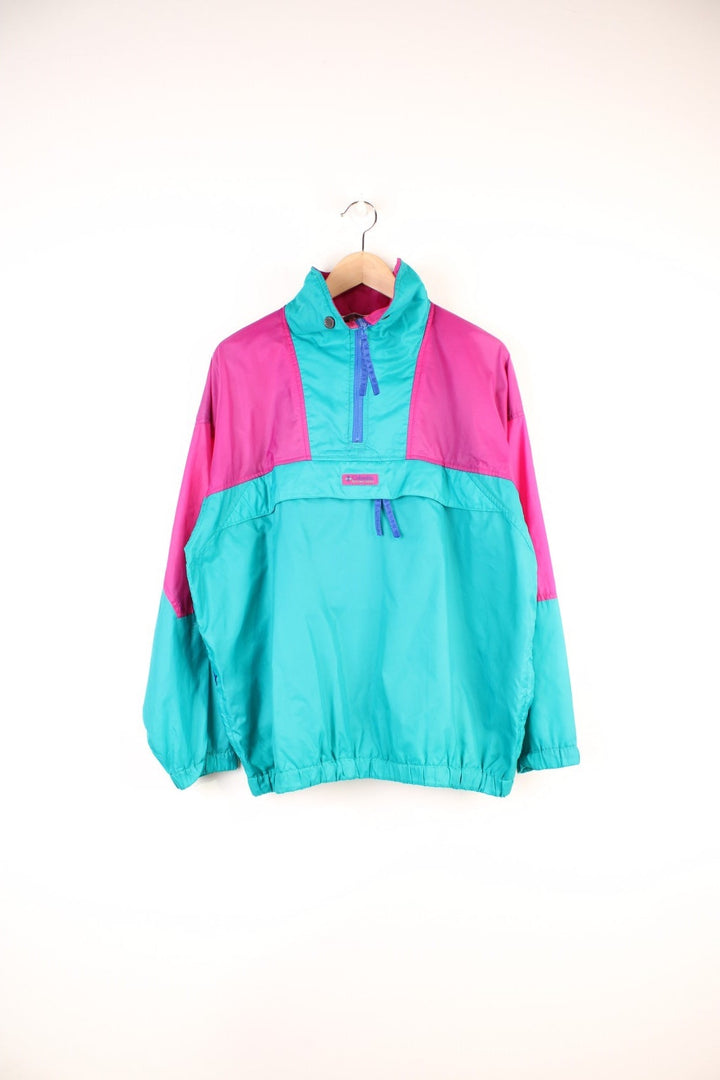 Columbia Lightweight Anorak Jacket in a pink and turquoise colourway, quarter zip up, pouch pockets, and has the logo embroidered on the front. 