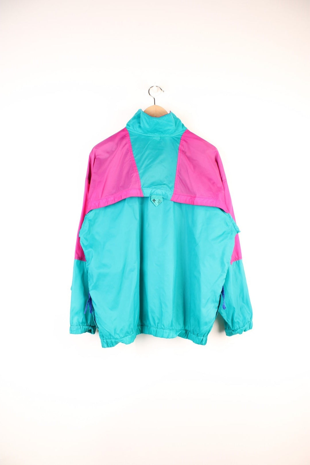 Columbia Lightweight Anorak Jacket in a pink and turquoise colourway, quarter zip up, pouch pockets, and has the logo embroidered on the front. 