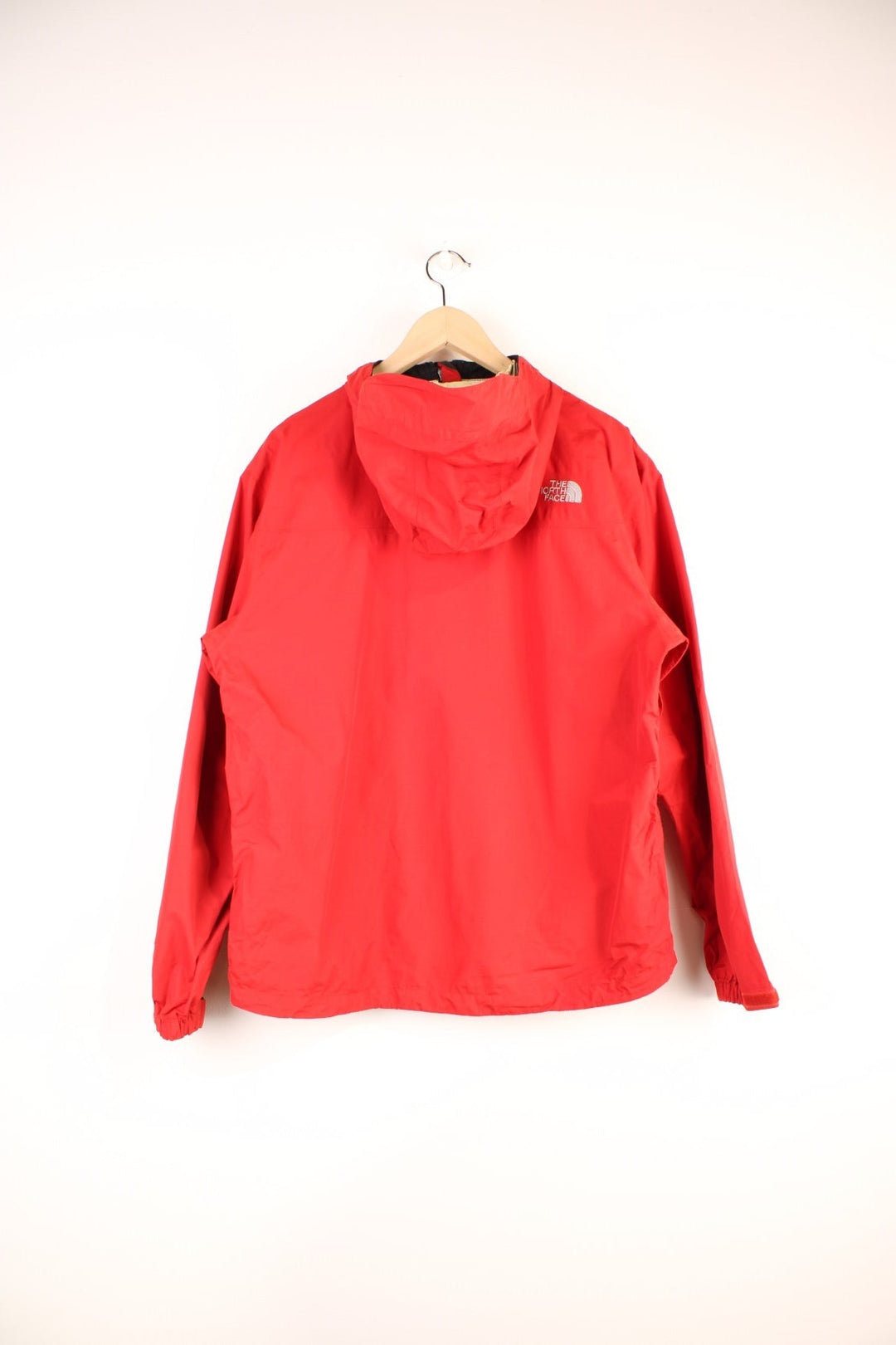 The North Face Hyvent Jacket in a red colourway, zip up with side pockets, hooded, and has the logo embroidered on the front and back. 