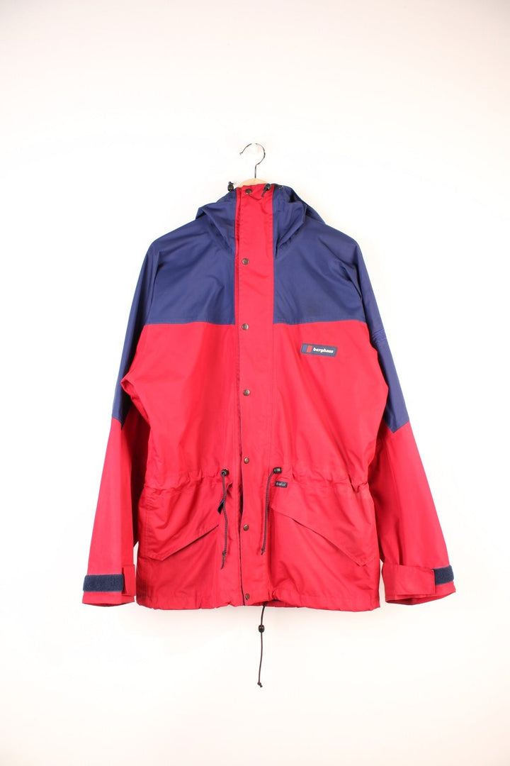 Vintage 90's Berghaus Mountain Trek Jacket in a red and blue colourway, zip up with side pockets, has a mesh lining, hooded and has the logo embroiderd on the front.