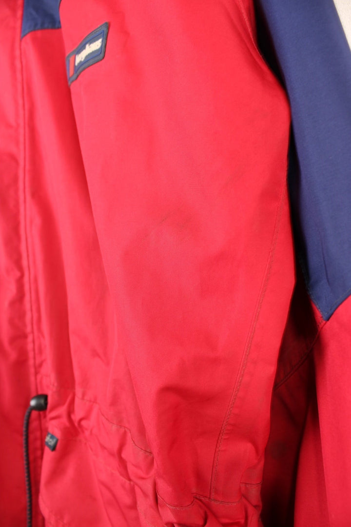 Vintage 90's Berghaus Mountain Trek Jacket in a red and blue colourway, zip up with side pockets, has a mesh lining, hooded and has the logo embroiderd on the front.