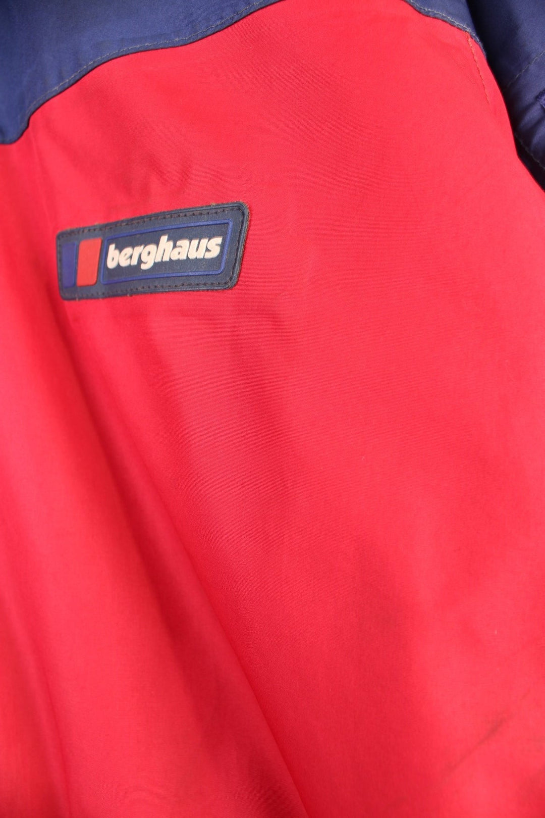 Vintage 90's Berghaus Mountain Trek Jacket in a red and blue colourway, zip up with side pockets, has a mesh lining, hooded and has the logo embroiderd on the front.