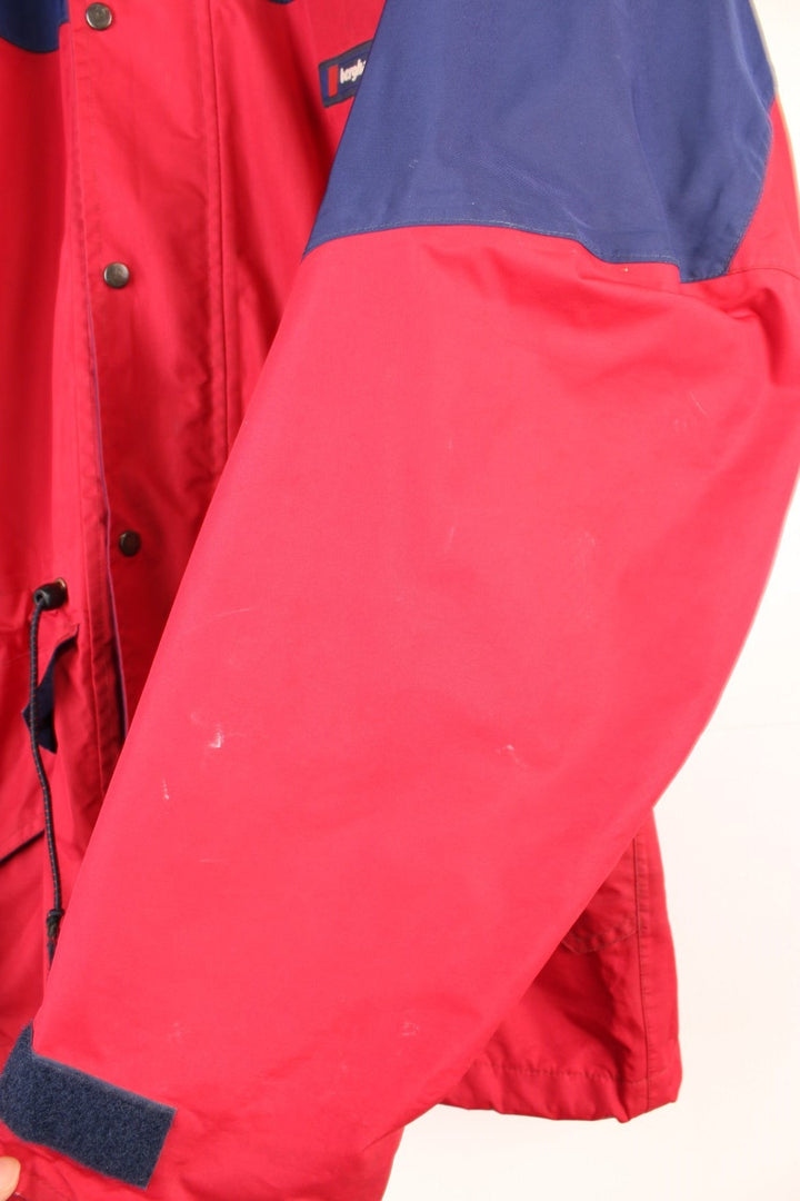 Vintage 90's Berghaus Mountain Trek Jacket in a red and blue colourway, zip up with side pockets, has a mesh lining, hooded and has the logo embroiderd on the front.