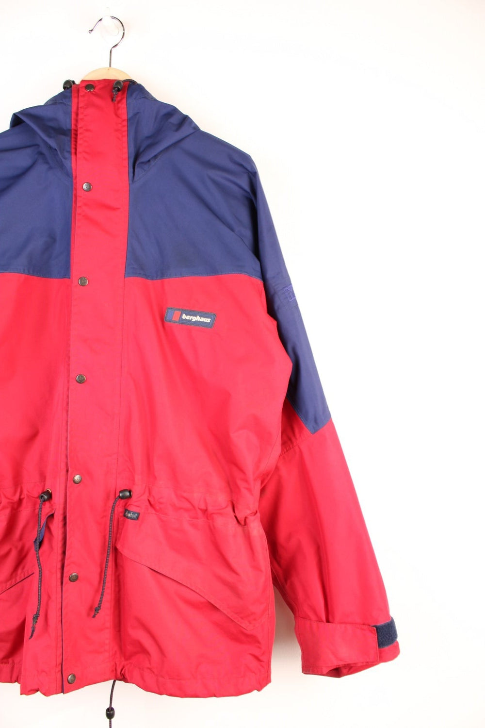 Vintage 90's Berghaus Mountain Trek Jacket in a red and blue colourway, zip up with side pockets, has a mesh lining, hooded and has the logo embroiderd on the front.