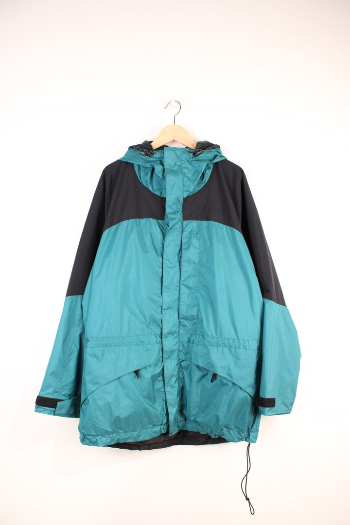 Marmot Gore-Tex Jacket in a green and black colourway, zip up with multiple pockets, mesh lining, hooded, and has the logo embroidered on the front. 