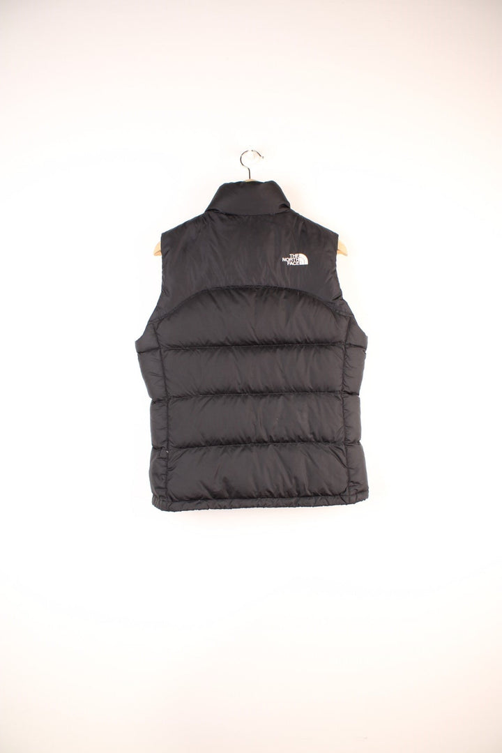 The North Face Gilet in a black colourway, zip up with side pockets, insulated, and has the logo embroidered on the front and back. 