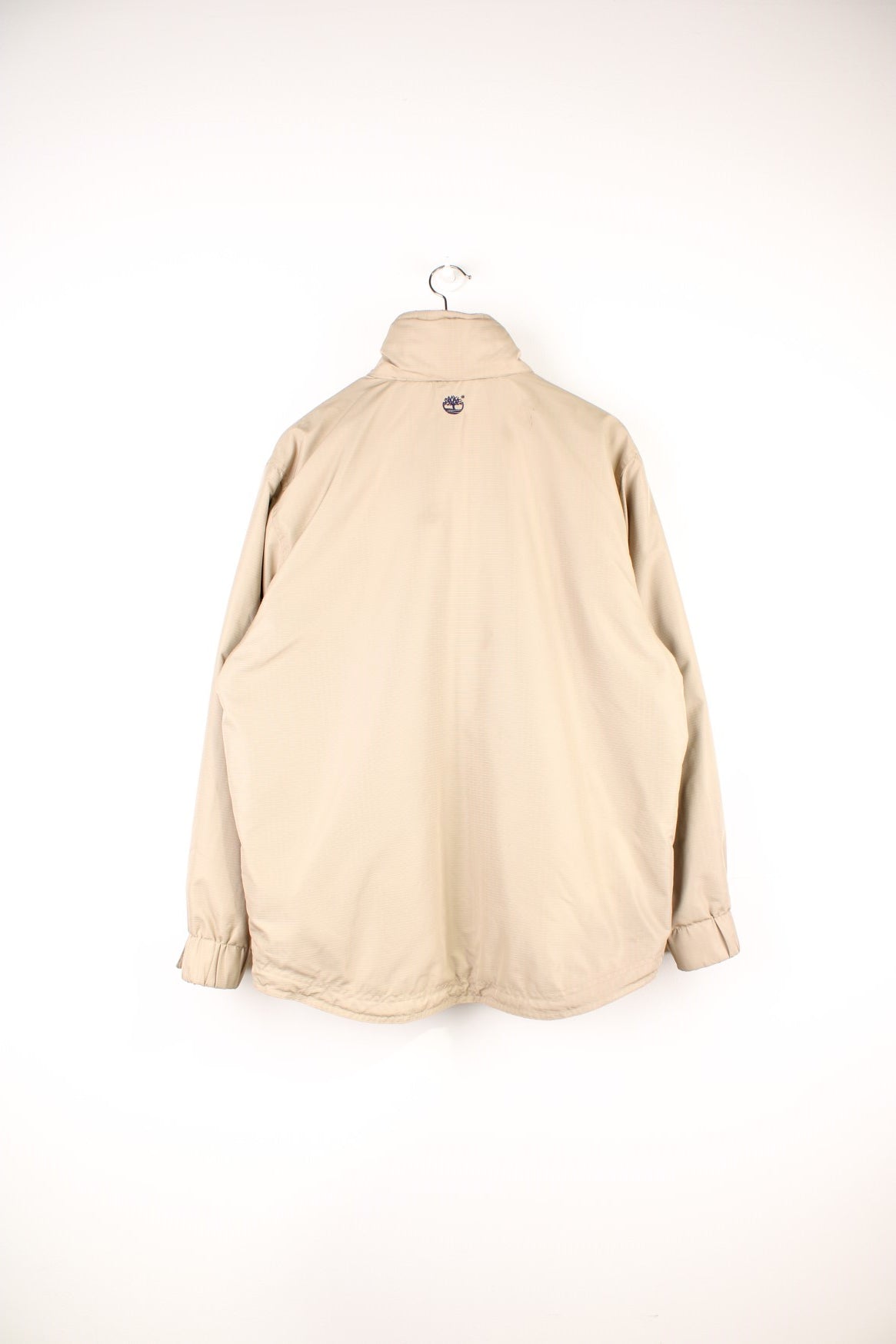 Timberland Jacket in a tanned colourway, zip and button up, side pockets, has a hideable hood, insulated with a fleece lining, and has the logo embroidered on the front and back. 