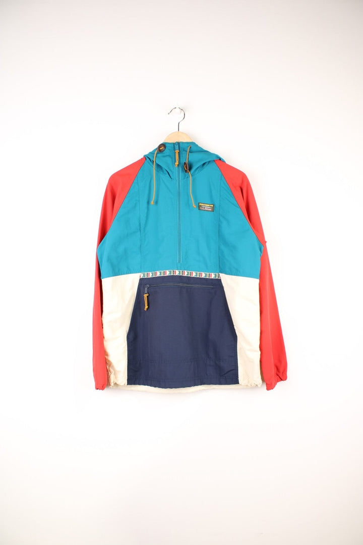 L.L. Bean Mountain Classic Anorak Jacket in a blue, red and white colourway, half zip up with pouch pockets, has an aztec pattern going across the front, hooded and has the logo embroidered on the chest. 