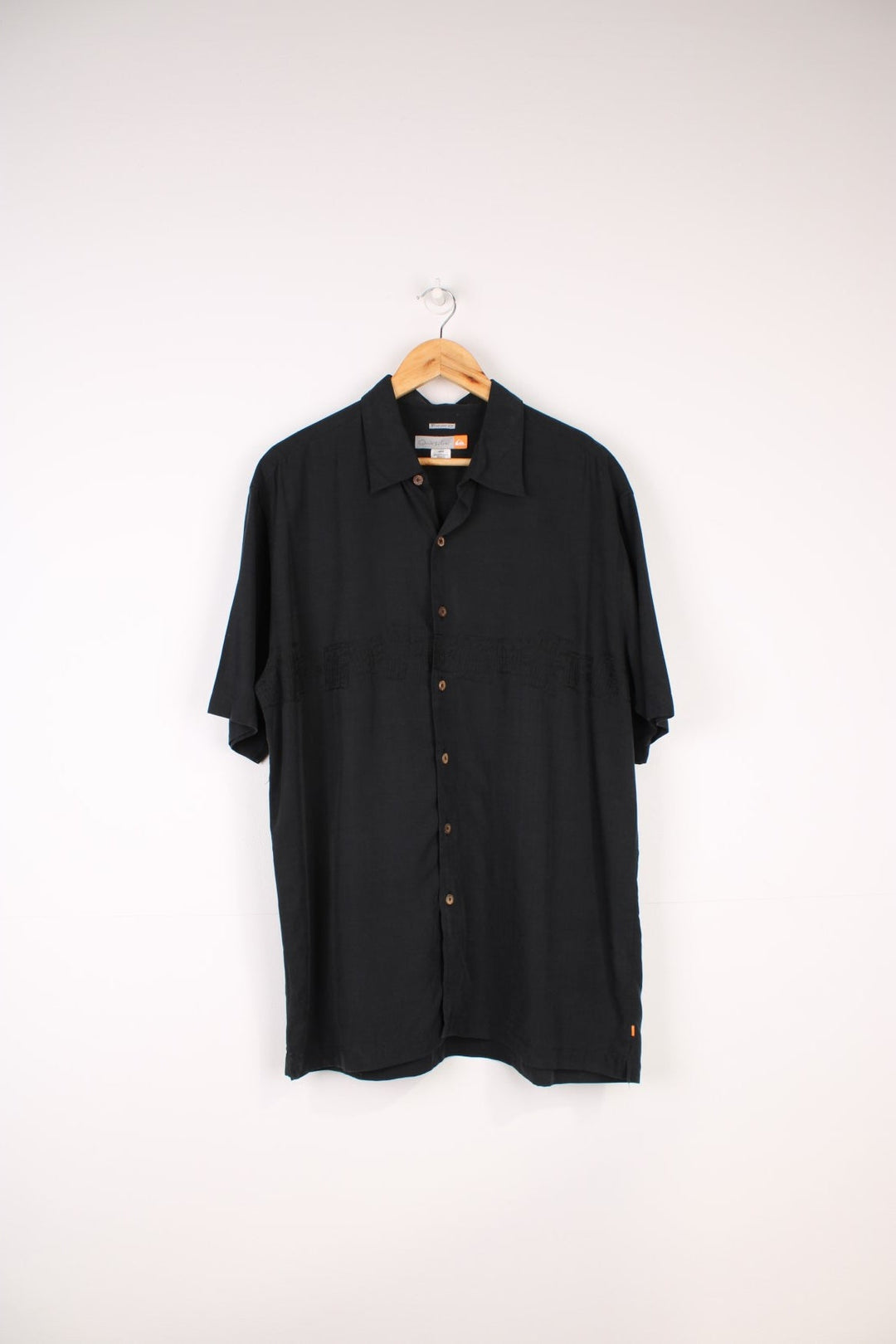 Quiksilver Surf Shirt in a black colourway with embroidered surfboard style design going across the front.