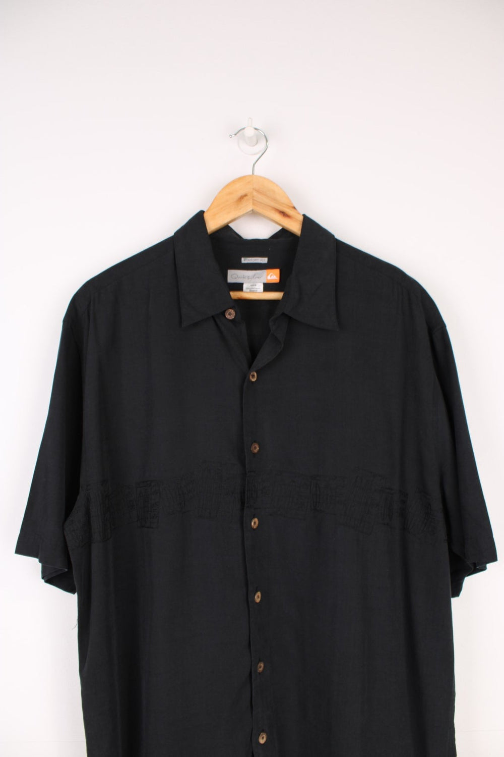 Quiksilver Surf Shirt in a black colourway with embroidered surfboard style design going across the front.