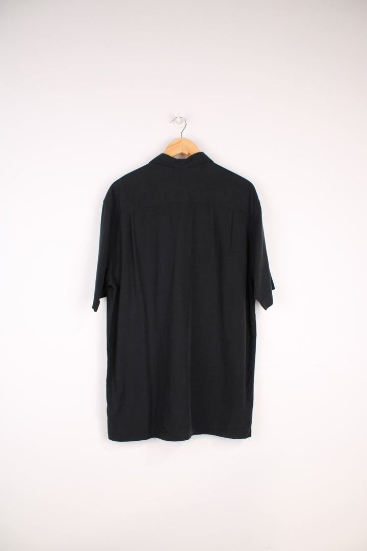 Quiksilver Surf Shirt in a black colourway with embroidered surfboard style design going across the front.