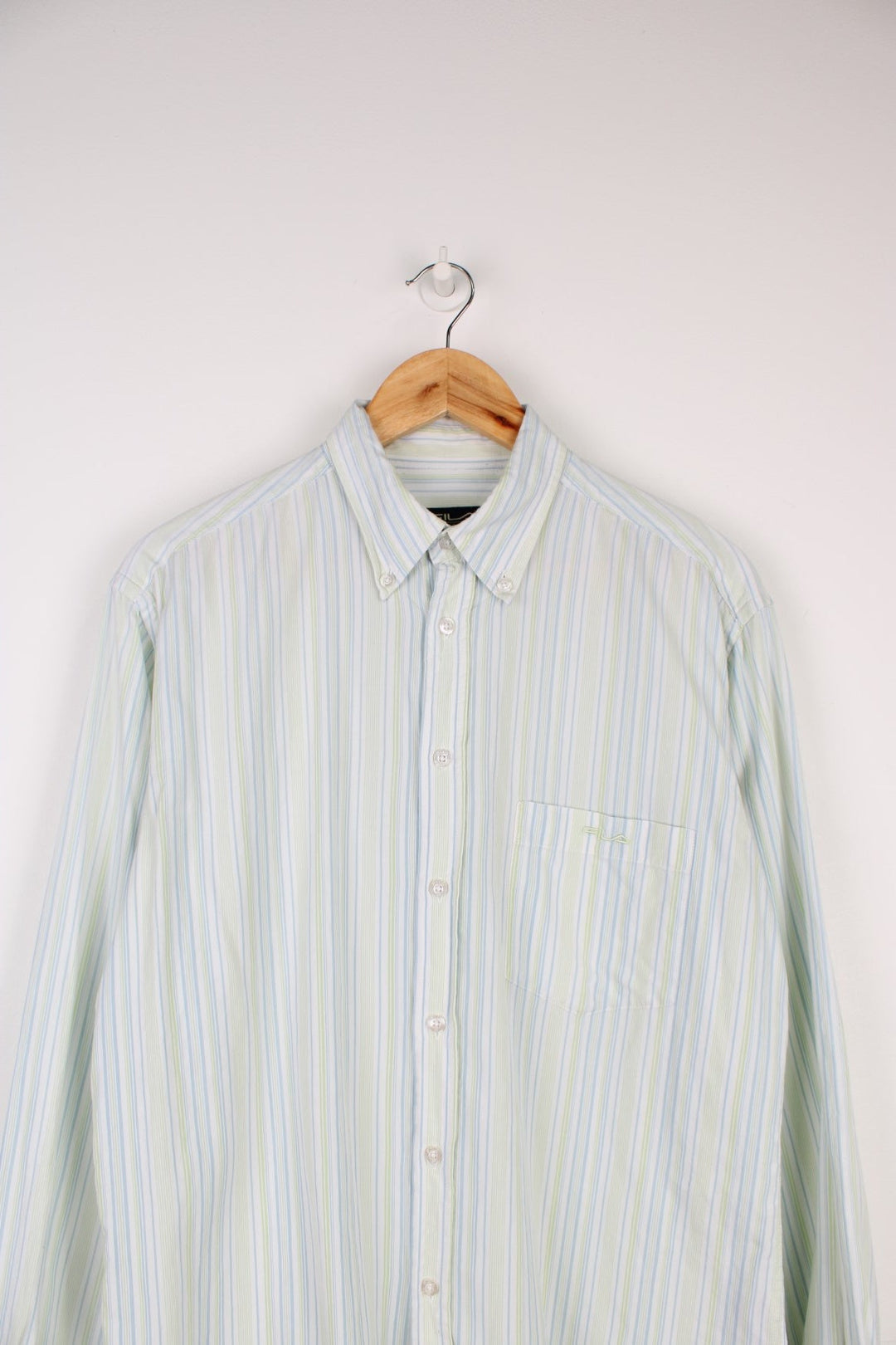 Fila Sport Classic Long Sleeved Shirt in a blue, white and green striped colourway, button up and has a chest pocket with the logo embroidered on it.