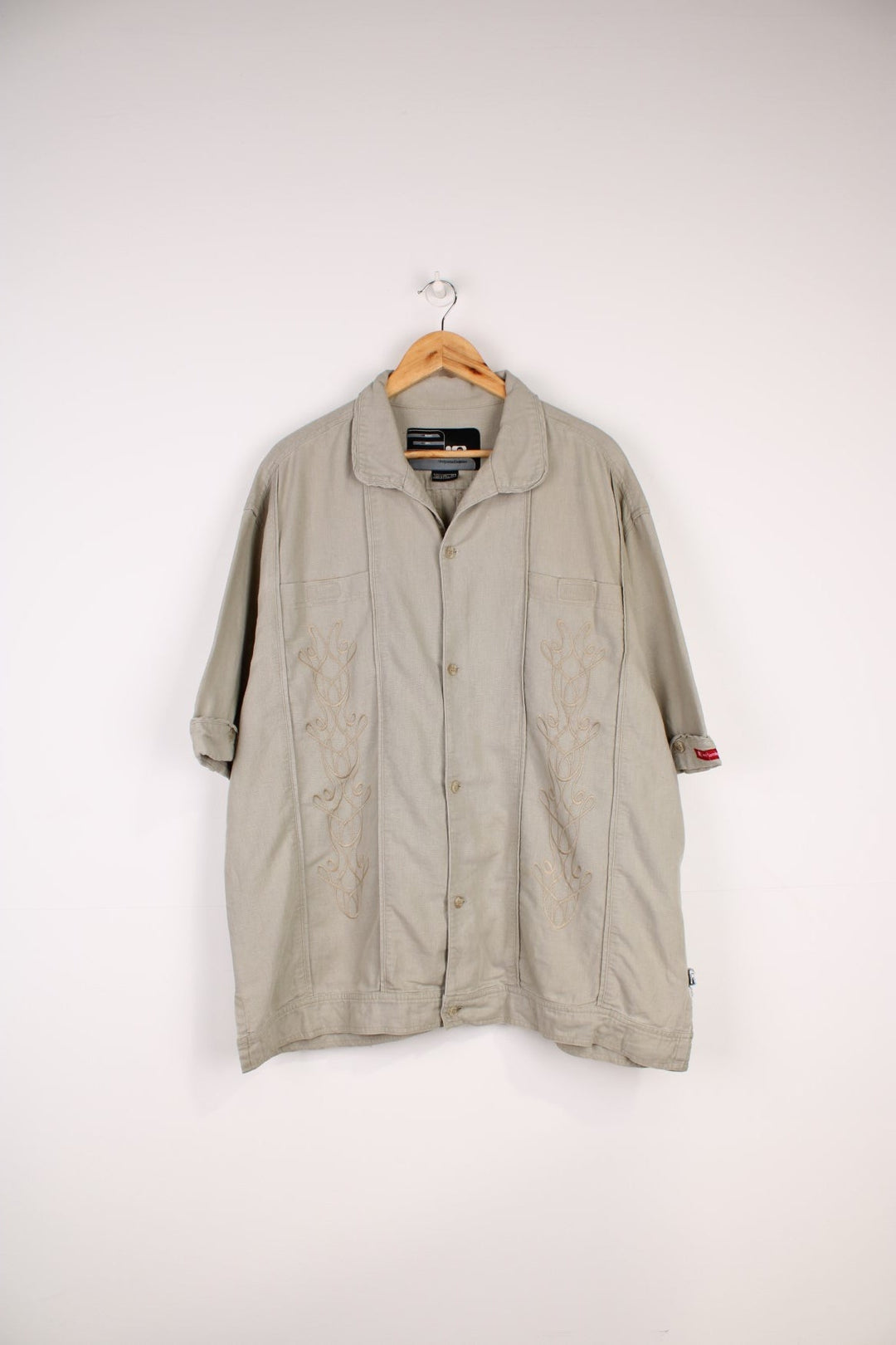 Nike Limited Edition Linen Shirt in a tanned colourway, similar style to a Cuban Guayabera shirts, button up with a camp collar, double chest pockets, and has embroidered floral pattern on the front. 