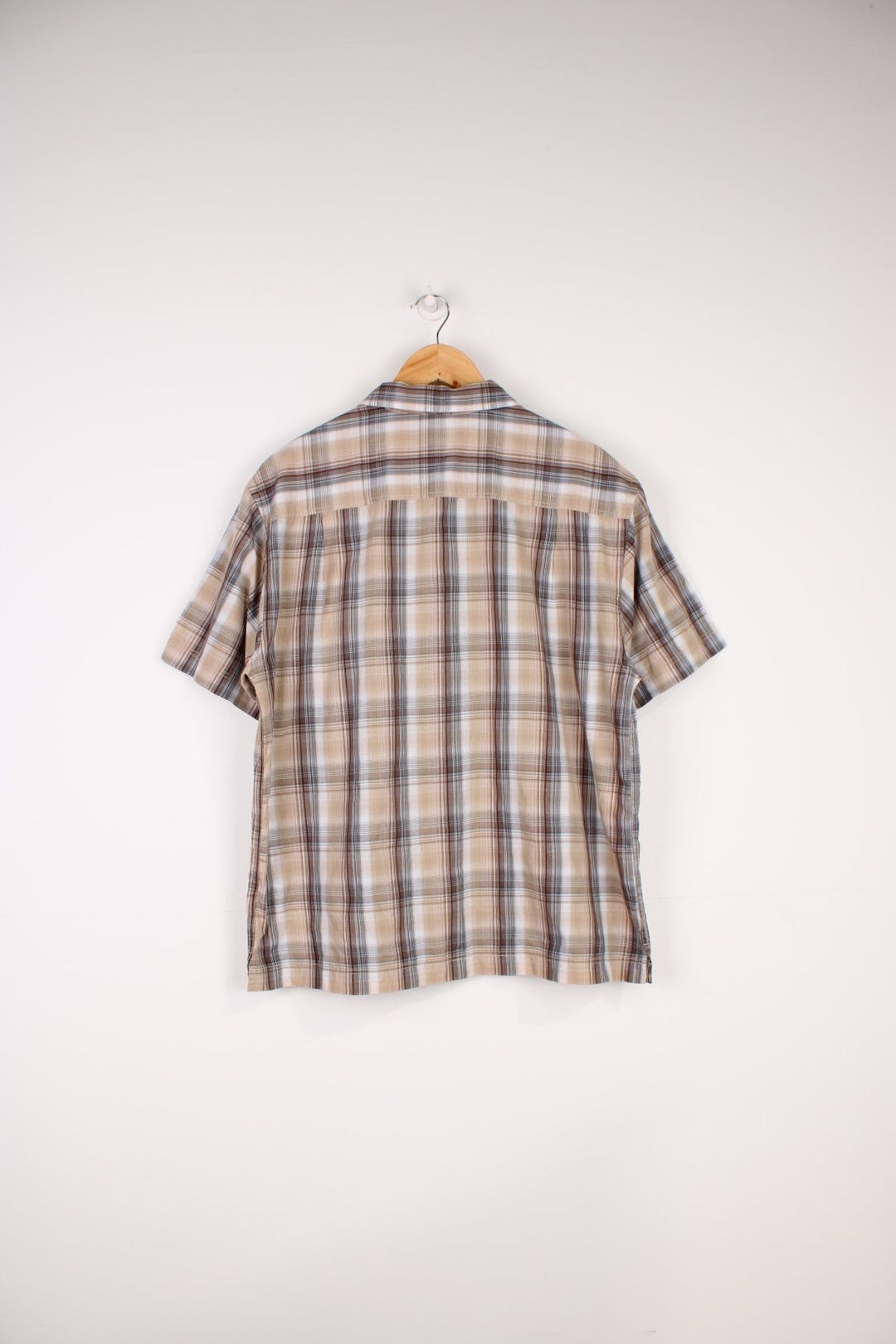 Berghaus Odyssey Shirt in a tanned brown, black and orange plaid colourway, button up shirt which has a chest pocket with the logo embroidered on it.