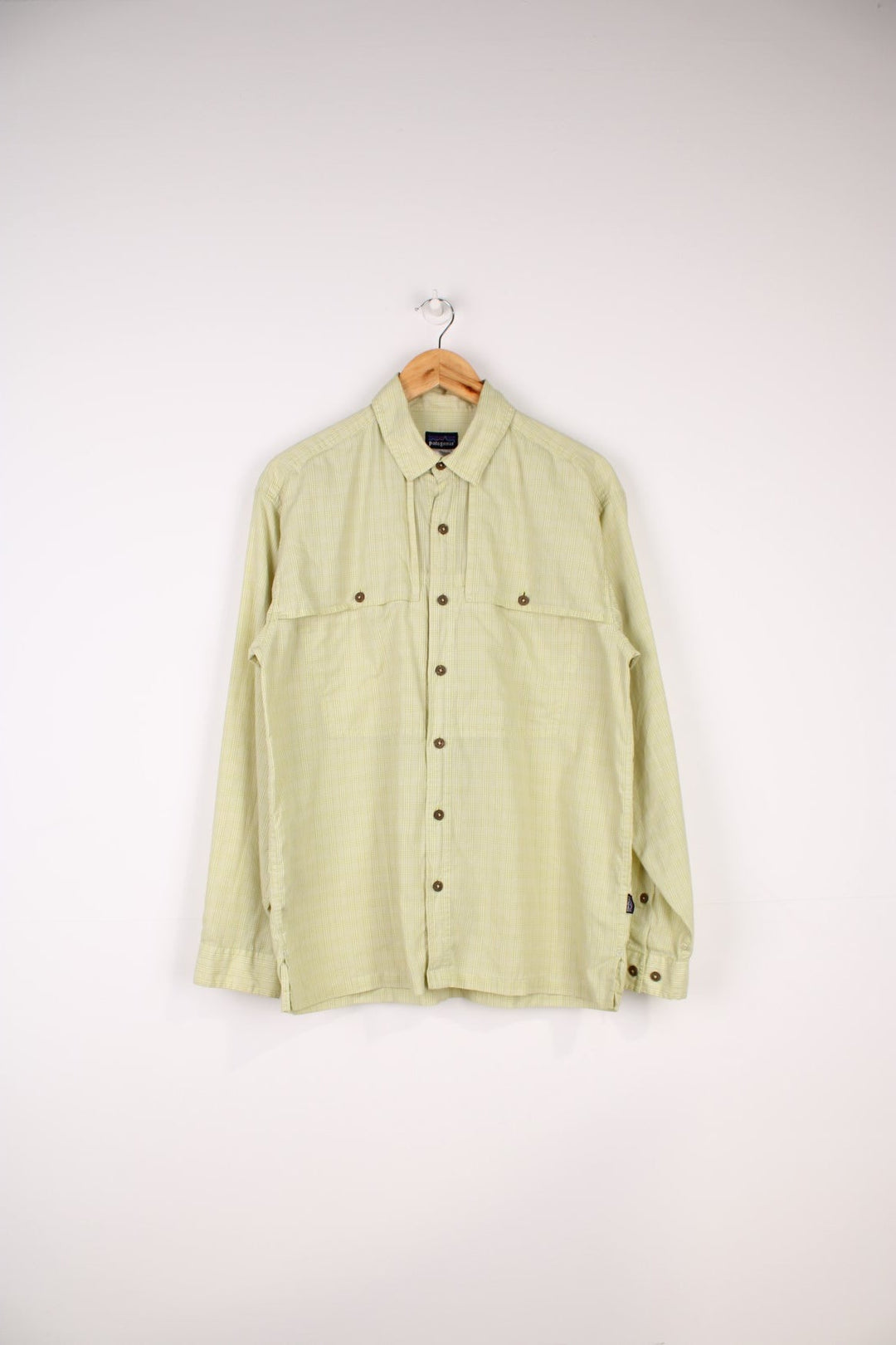 Patagonia Vented Shirt in a green checkered colourway, button up with double chest pockets which overlaps as an air vent, also has the logo embroidered on the side.